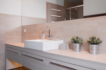 Porcelain washbasin in bright bathroom