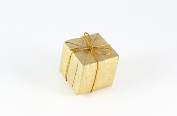 Gift box wrap gold paper with gold ribbon and isolated background 