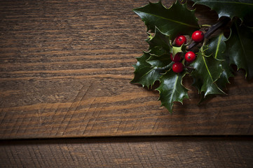 Photo of Holly leafs on old wooen table