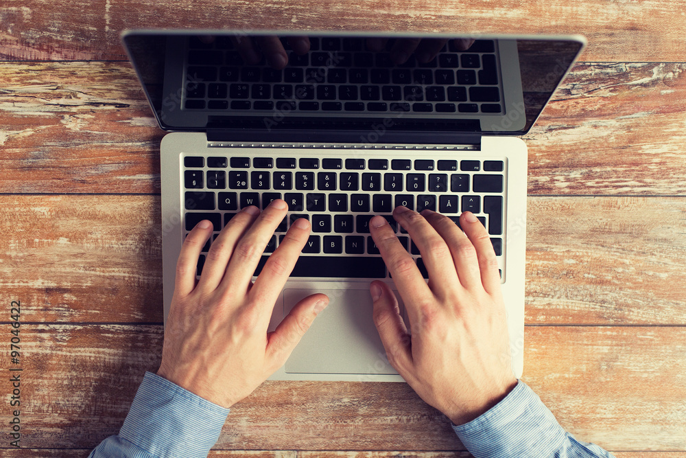 Sticker close up of male hands with laptop typing