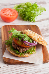 Burger with a vegetarian cutlet and fresh vegetables, close-up