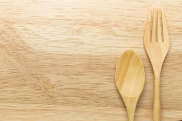 Wooden spoon and fork on wood background