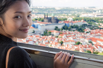 Fototapeta premium Woman watches cityscape of Prague from outlook tower