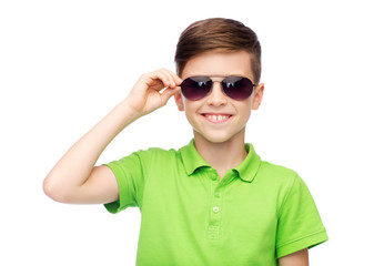 smiling boy in sunglasses and green polo t-shirt