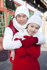 Happy couple hugging in Hutong Yard