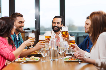 friends dining and drinking beer at restaurant
