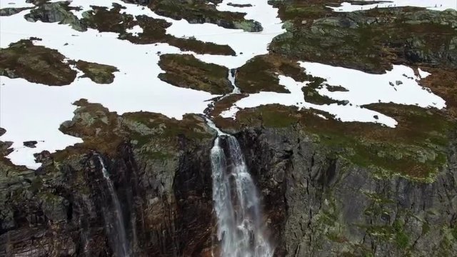 Aerial footage of beautiful tall waterfall in Norway, near one of the main tourist attractions in Norway, Trolltunga rock. Aerial 4k Ultra HD.