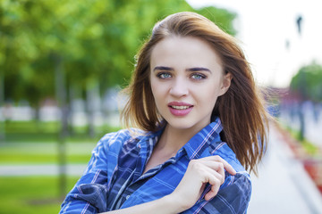 Naklejka premium Close up of young beautiful woman in a checkered blue shirt