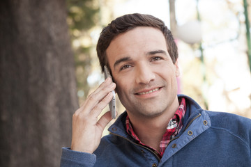 Man sitting in the street using the cellphone