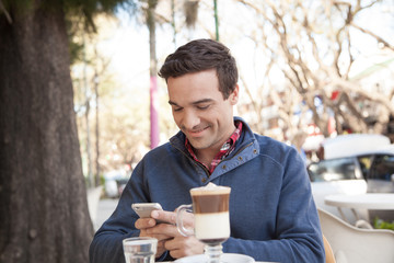 Man sitting in the street using the cellphone