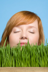 Woman smelling grass