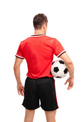 Young football player holding a ball