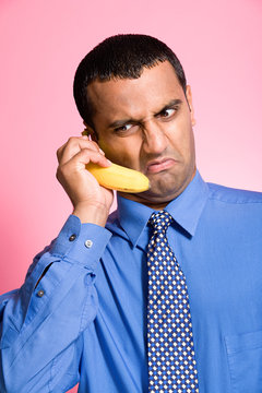 Man using a banana as a telephone