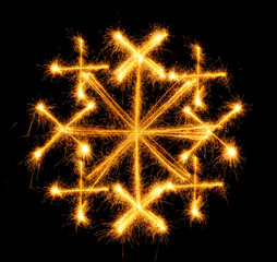 Snowflake made by sparkler on a black