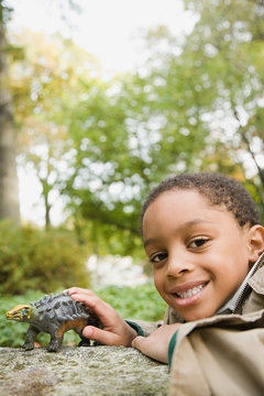 Boy with toy dinosaur