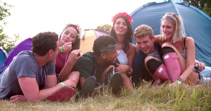 Friends having fun on the campsite at a music festival