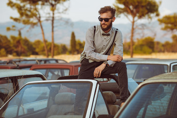 Fototapeta premium Young handsome stylish man, wearing shirt and bow-tie on the fie