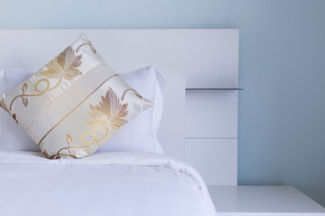 luxury pillow on white bed sheets blue wall