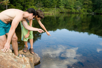Boy and father looking at lake