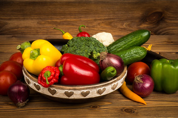 Fresh vegetables in the wooden box on the rustic background.