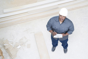 A builder inspecting a house