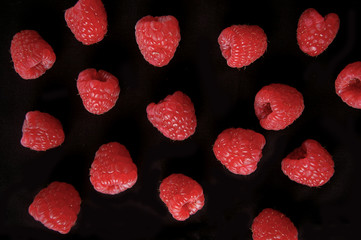 Raspberry fruit pattern on black background