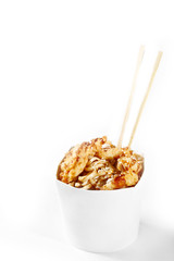 Delicious wok noodles box with tempura chicken and udon. Chinese and asian takeaway fast food. Studio isolated with real shadow