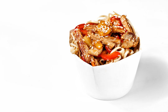Delicious wok noodles box with pork and udon. Chinese and asian takeaway fast food. Studio isolated with real shadow