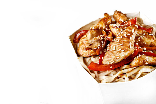 Delicious Wok Noodles Box With Chicken And Udon. Chinese And Asian Takeaway Fast Food. Studio Isolated With Real Shadow