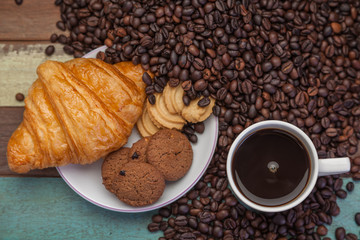 Cup of coffee with cookies and beans