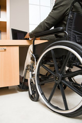 Fototapeta premium Rear view of a disabled man in a wheelchair