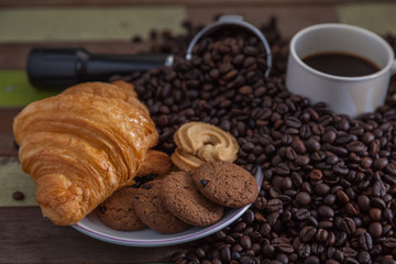 Cookies with cup of coffee with beans