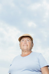 Senior woman against cloudy sky