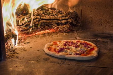 Foto auf Glas Pizza with smoked cheese and sausage in a traditional wood oven © staraldo