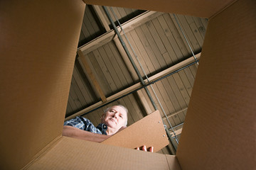 Man looking in cardboard box