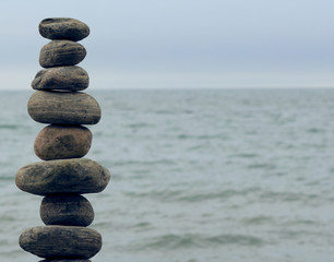 Fototapeta na wymiar stack of stones on the shore of a lake