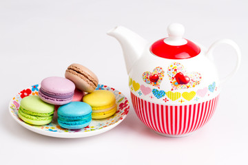 Collection of brightly colored French macarons on white background, tea