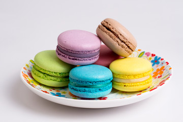 Fototapeta na wymiar Collection of brightly colored French macarons on white background