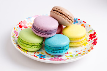 Collection of brightly colored French macarons on white background