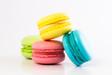 Collection of brightly colored French macarons on white background
