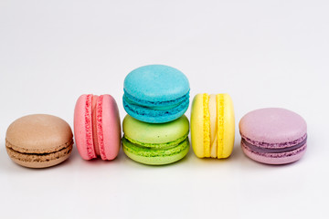 Collection of brightly colored French macarons on white background