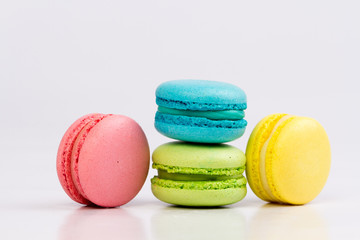 Collection of brightly colored French macarons on white background