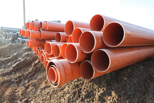 red plastic water pipes construction site