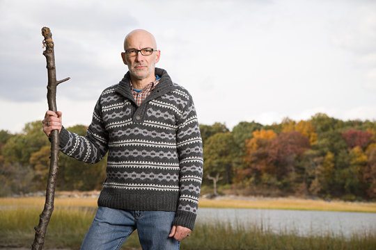 Mature Man Holding A Stick