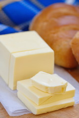 Fresh butter and bread on the wooden table