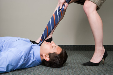 Woman pulling manager's tie