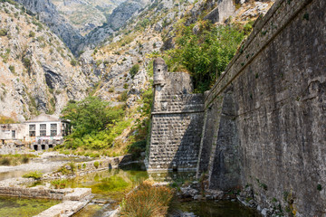 Fototapeta na wymiar The fortress wall of bastion Bembo near the river Shkurda, the Old town of Kotor, Montenegro