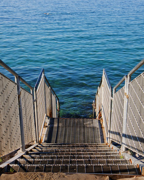 steps to the transparent Adriatic sea waters on the free strand of Barcola, Trieste, Italy