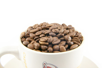 Cup full of coffee beans isolated