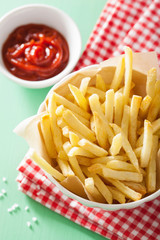 french fries with ketchup over green background
